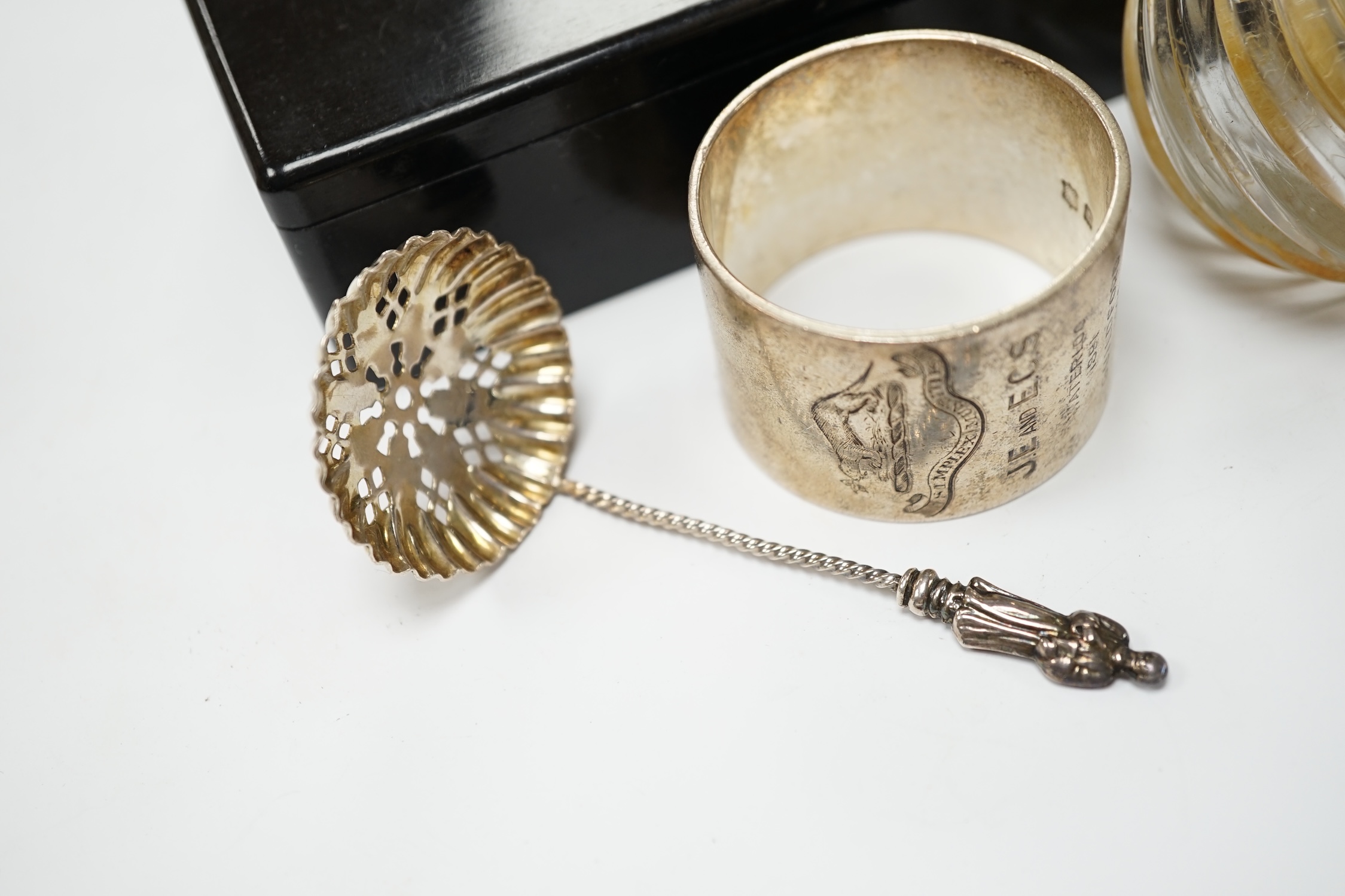 Four assorted silver mounted glass toilet jars, an Edwardian silver mounted glass mustard jar with spoon, a silver napkin ring, sifter spoon and ebony box. Condition - poor to fair